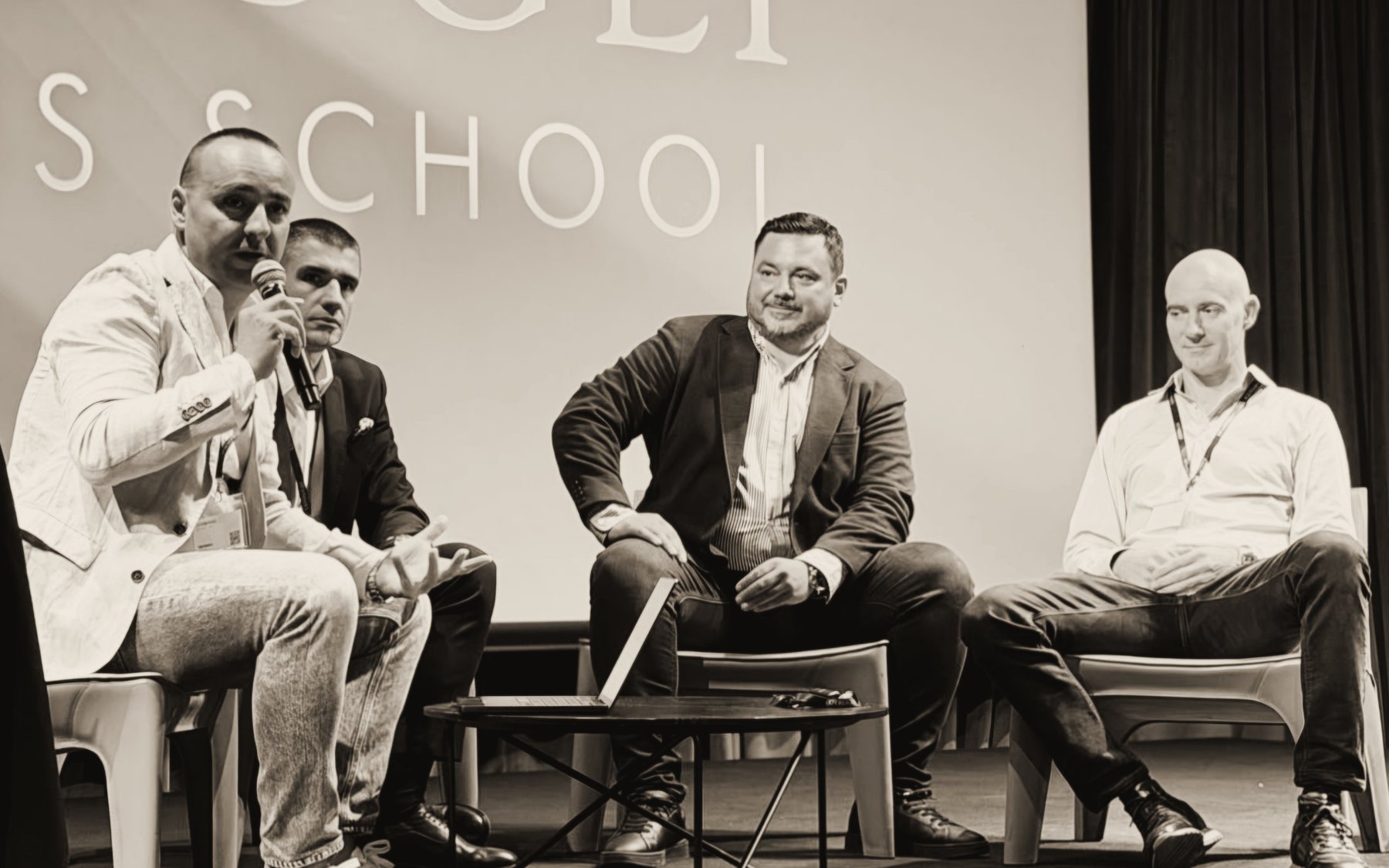 Panel discussion on stage at COTRUGLI Business School